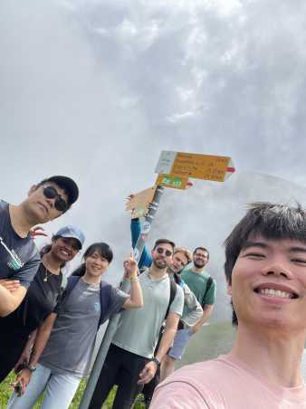 Group picture in front of a guide sign on a hiking trail