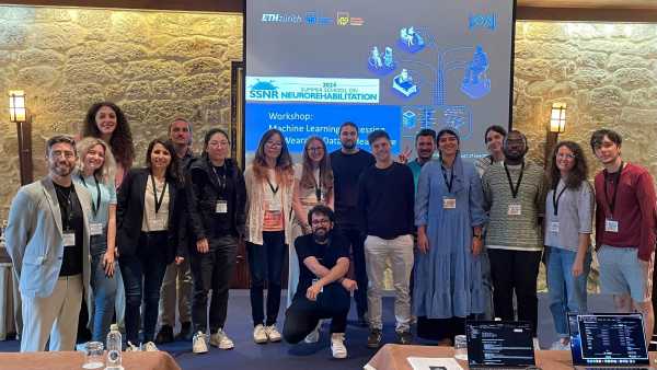 Group picture at a conference in front of a presentation screen