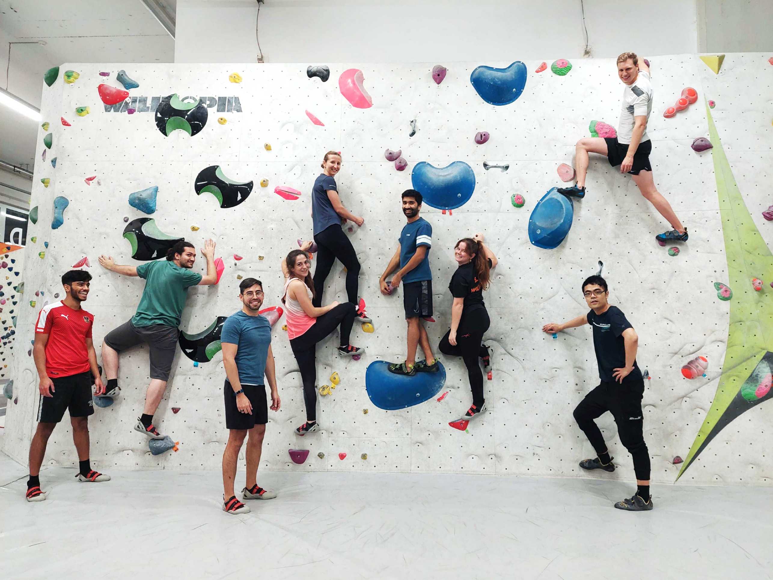 Enlarged view: Group picture of the SCAI group during the excursion to climbing hall. Several people are hanging on the climbing wall